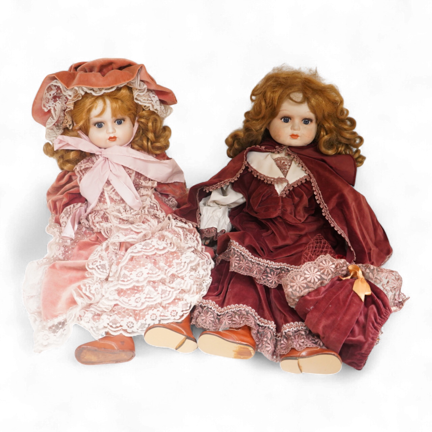 Two bisque dolls in matching Victorian clothing, 60cm high